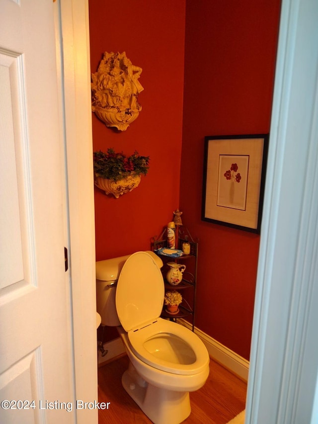 bathroom featuring hardwood / wood-style flooring and toilet