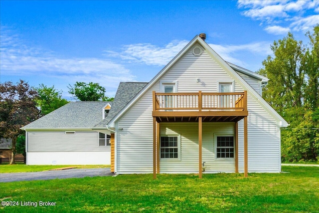 back of house with a deck and a lawn