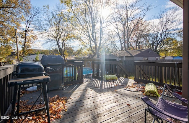 wooden deck featuring a grill