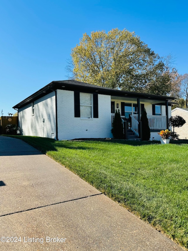 ranch-style home with a front lawn