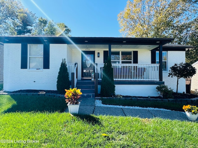 view of front of home with a porch and a front lawn