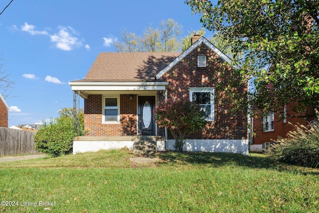 view of front of property with a porch and a front lawn