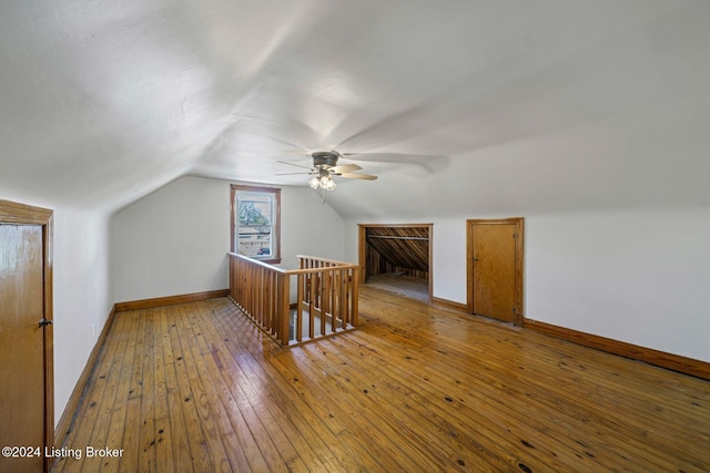 additional living space featuring wood-type flooring, vaulted ceiling, and ceiling fan