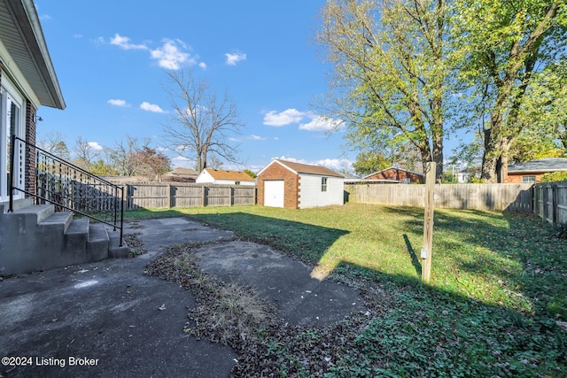 view of yard featuring an outbuilding and a patio