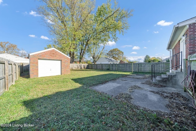 view of yard with a garage and an outdoor structure