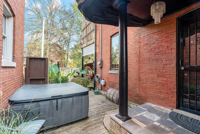 wooden terrace featuring a hot tub