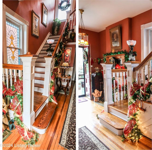 foyer entrance featuring hardwood / wood-style floors, a healthy amount of sunlight, and a notable chandelier