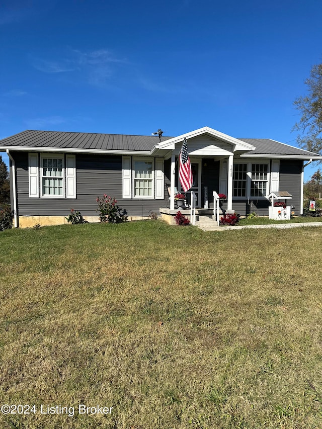 ranch-style house with a front yard and covered porch