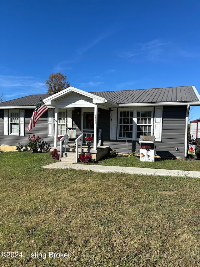 view of front of house with a front yard and a porch