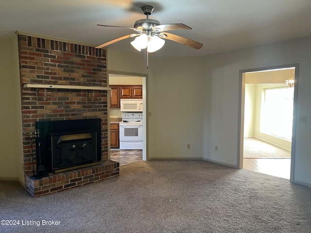 unfurnished living room featuring ceiling fan and carpet