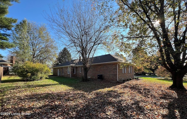 view of side of home featuring a lawn