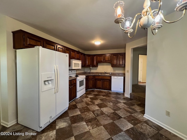 kitchen featuring decorative light fixtures, white appliances, dark brown cabinetry, sink, and a chandelier