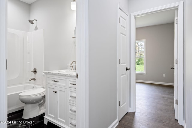 full bathroom featuring hardwood / wood-style flooring, vanity, toilet, and shower / bathing tub combination