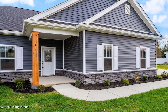 view of exterior entry with a porch