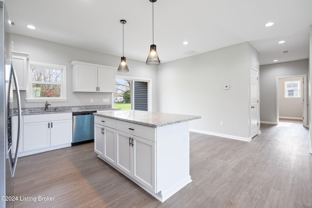 kitchen with white cabinetry, plenty of natural light, dishwasher, and a center island