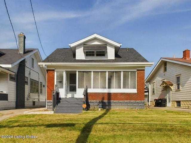 bungalow featuring a sunroom and a front yard