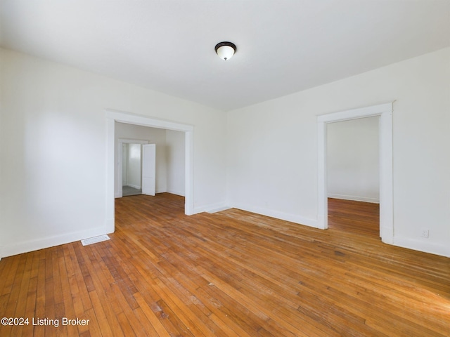 empty room with light hardwood / wood-style flooring