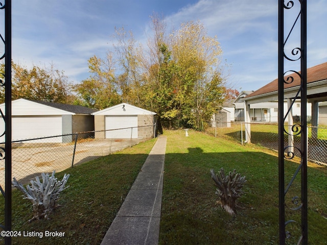 view of yard featuring an outbuilding and a garage