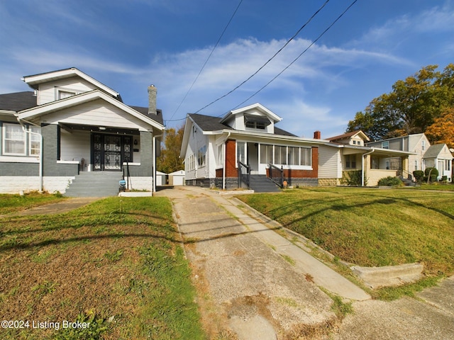 bungalow-style house featuring a front yard