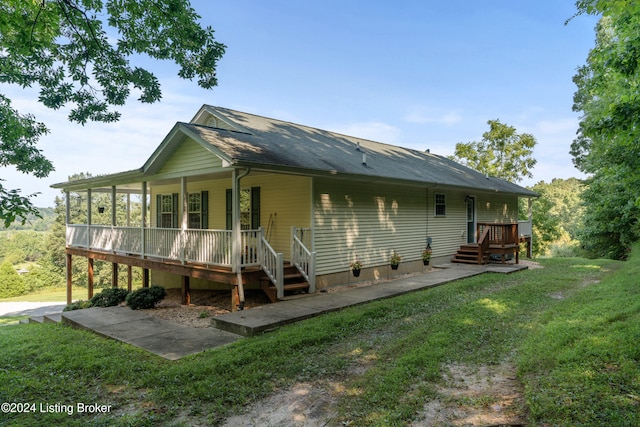 rear view of house with a yard