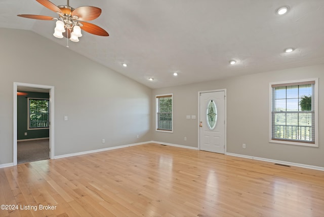 foyer featuring a wealth of natural light, vaulted ceiling, ceiling fan, and light hardwood / wood-style flooring