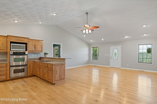 kitchen featuring stainless steel appliances, high vaulted ceiling, kitchen peninsula, ceiling fan, and light hardwood / wood-style flooring