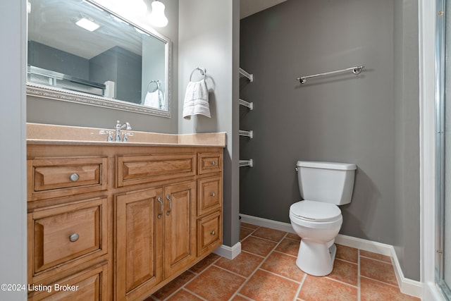 bathroom featuring toilet, vanity, and tile patterned floors