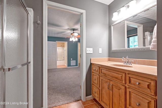 bathroom featuring tile patterned floors, a textured ceiling, vanity, ceiling fan, and a shower with shower door