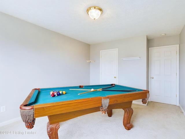 recreation room featuring a textured ceiling, light carpet, and billiards