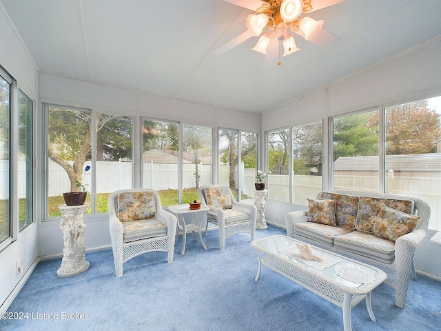 sunroom / solarium with ceiling fan, lofted ceiling, and a wealth of natural light