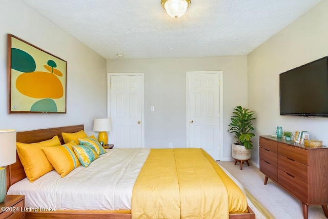 carpeted bedroom with a textured ceiling