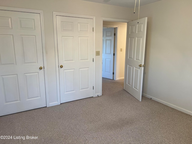 unfurnished bedroom featuring light colored carpet