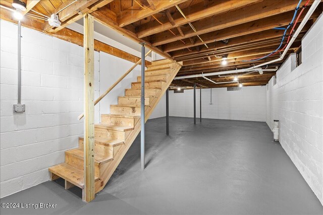 314 S Lincoln Blvd, Hodgenville, KY 42748 - unfinished basement featuring stairway and concrete block wall