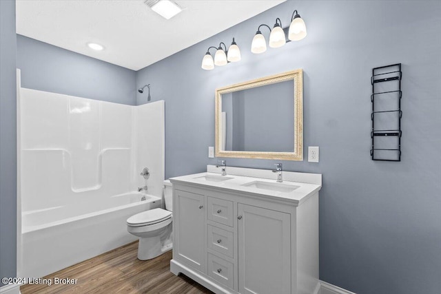 314 S Lincoln Blvd, Hodgenville, KY 42748 - bathroom with toilet, double vanity, washtub / shower combination, and wood finished floors
