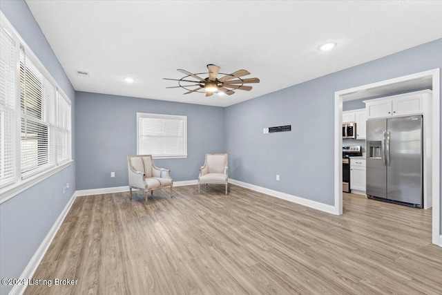 unfurnished room featuring ceiling fan, a healthy amount of sunlight, and light hardwood / wood-style flooring