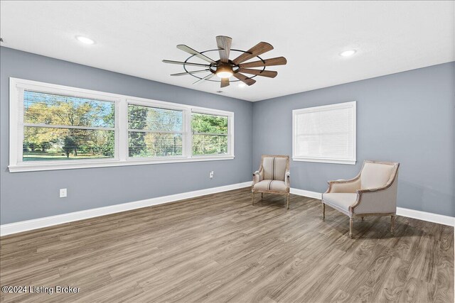 unfurnished room featuring hardwood / wood-style flooring and ceiling fan