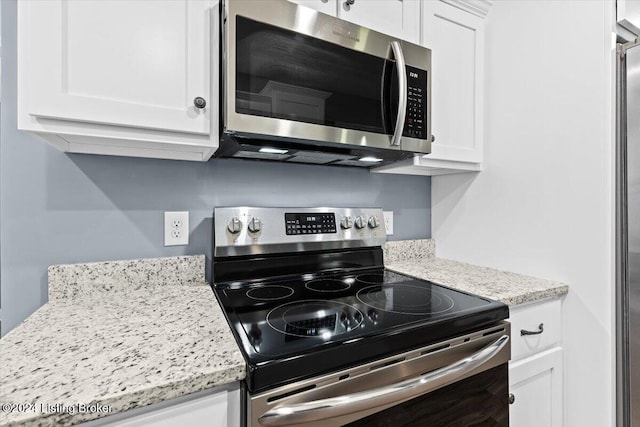 314 S Lincoln Blvd, Hodgenville, KY 42748 - kitchen with appliances with stainless steel finishes, white cabinetry, and light stone countertops