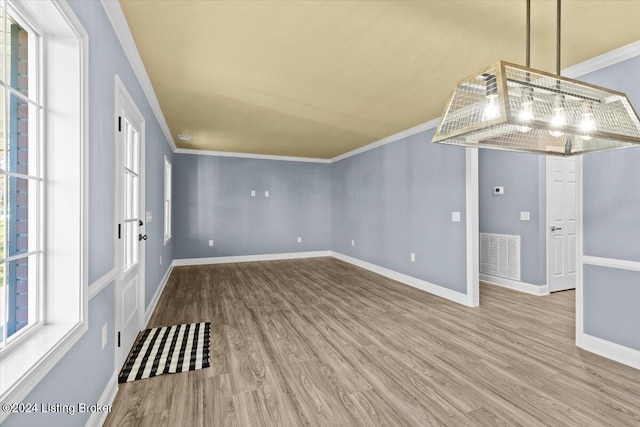 interior space featuring wood-type flooring and ornamental molding