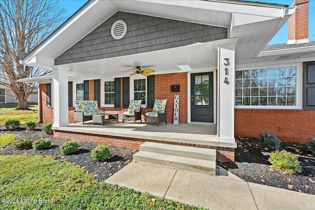 view of exterior entry with a porch and ceiling fan