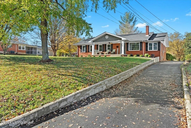 ranch-style house with a porch and a front yard