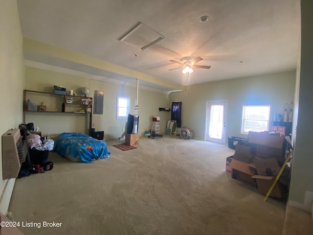 bedroom featuring multiple windows, carpet flooring, electric panel, and ceiling fan