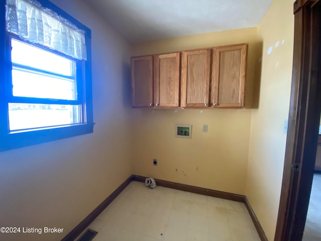 laundry area featuring cabinets, hookup for a washing machine, and hookup for an electric dryer