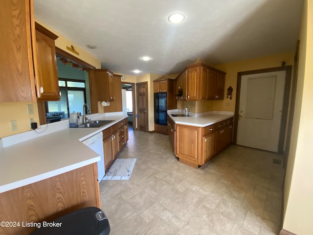 kitchen featuring double oven, sink, kitchen peninsula, and dishwasher