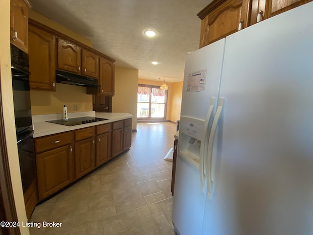 kitchen with hanging light fixtures and black appliances