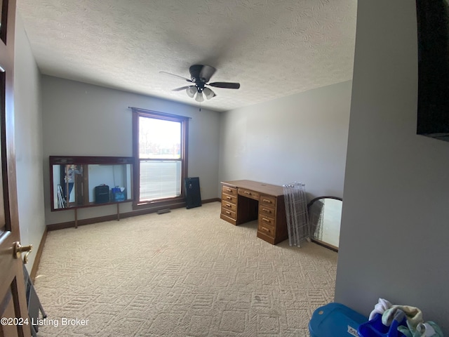 miscellaneous room with ceiling fan, light carpet, and a textured ceiling