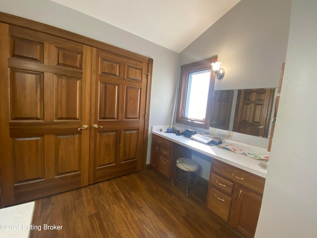 bathroom featuring lofted ceiling and hardwood / wood-style floors