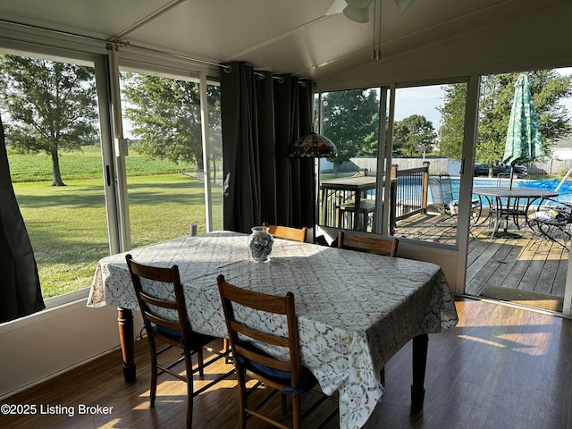 sunroom / solarium featuring vaulted ceiling