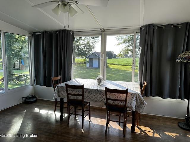 dining room featuring vaulted ceiling, dark hardwood / wood-style floors, and ceiling fan