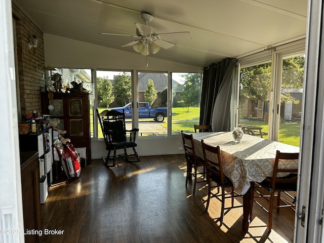 sunroom featuring lofted ceiling and ceiling fan