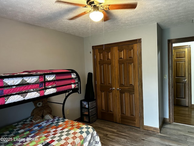 bedroom featuring a textured ceiling, a closet, ceiling fan, and hardwood / wood-style flooring